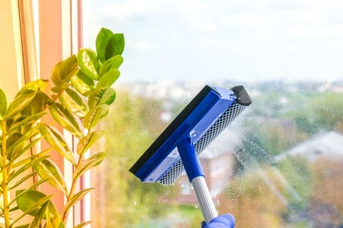Streak-free window cleaning technique demonstrated on a home window in Hanford, CA